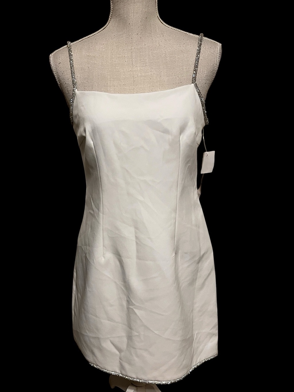 Mini prom dress by Aqua. White fabric has a subtle sheen, gemstone straps . Sz S